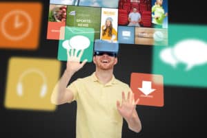 3d technology, virtual reality, entertainment, media and people concept - happy young man in virtual reality headset or 3d glasses playing game over black background with screens and computer icons
