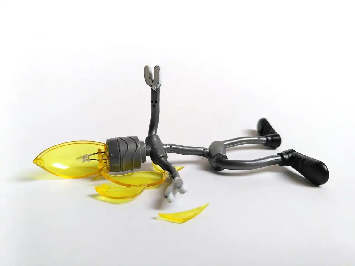 Broken light with shattered yellow lens on a white background